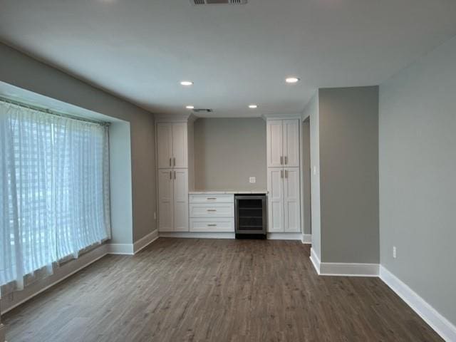 42 Boimare Ave, Kenner, LA 70065 - unfurnished living room with wine cooler, baseboards, dark wood-style flooring, and recessed lighting