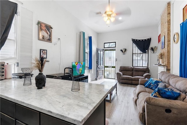 2612-14 Orleans Ave, New Orleans, LA 70119 - kitchen featuring open floor plan, ceiling fan, light wood-style floors, and dark cabinetry