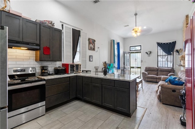 2612-14 Orleans Ave, New Orleans, LA 70119 - kitchen featuring appliances with stainless steel finishes, under cabinet range hood, a peninsula, light wood finished floors, and open floor plan