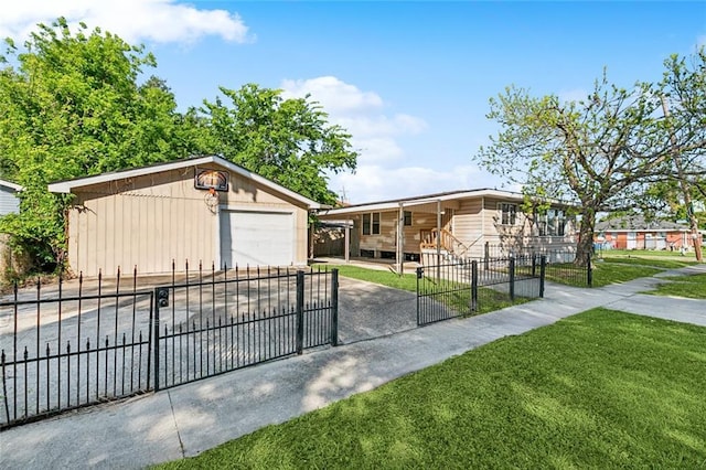 8936 Curran Blvd, New Orleans, LA 70127 - view of front of house featuring a detached garage, a fenced front yard, concrete driveway, an outbuilding, and a front yard