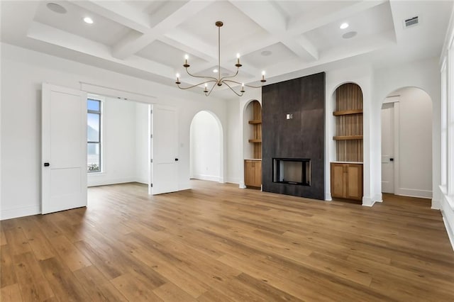 1161 Audubon Pkwy, Madisonville, LA 70447 - unfurnished living room with arched walkways, coffered ceiling, visible vents, and baseboards