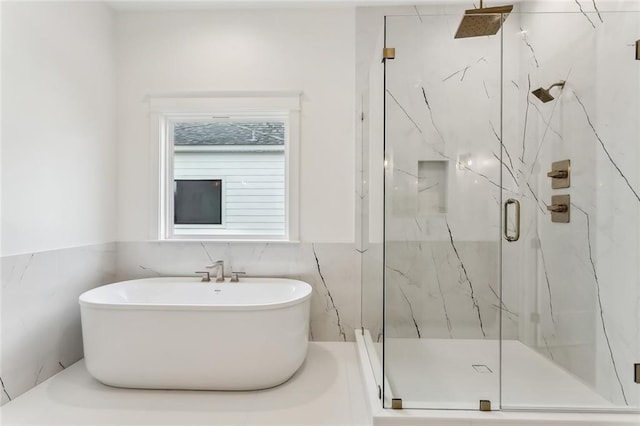 1161 Audubon Pkwy, Madisonville, LA 70447 - bathroom with a soaking tub, wainscoting, a marble finish shower, and tile walls
