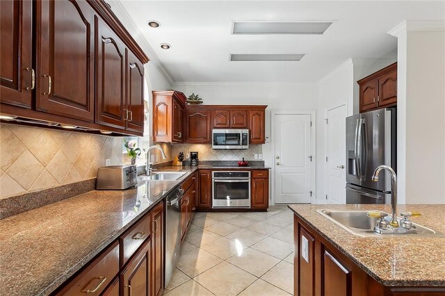 4344 Idaho Ave, Kenner, LA 70065 - kitchen featuring light tile patterned floors, backsplash, appliances with stainless steel finishes, and a sink