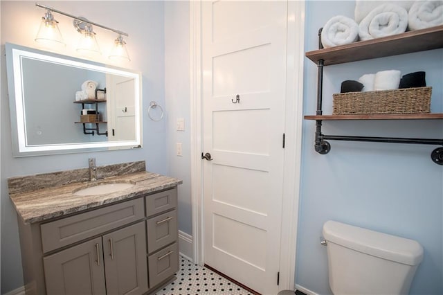 1529 Saint Philip St, New Orleans, LA 70116 - bathroom with toilet, vanity, and baseboards