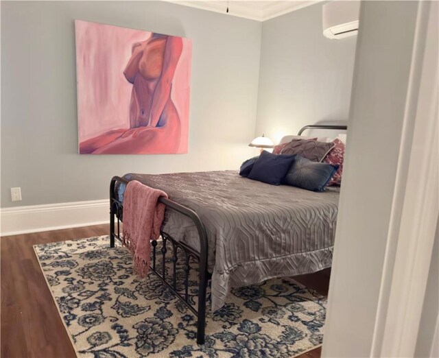 1529 Saint Philip St, New Orleans, LA 70116 - bedroom featuring a wall unit AC, crown molding, wood finished floors, and baseboards