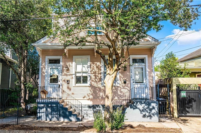 shotgun-style home featuring fence