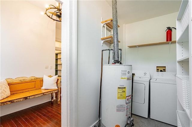 interior space with washer and dryer, wood finished floors, and gas water heater
