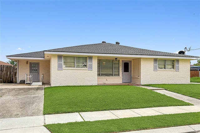 4901 Coronado Dr, New Orleans, LA 70127 - ranch-style house with brick siding, a front yard, and fence