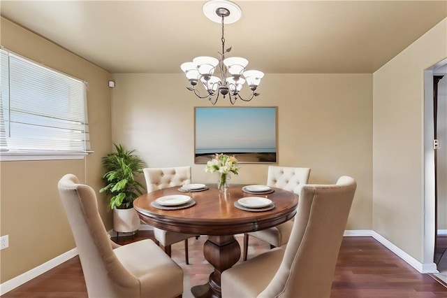 4901 Coronado Dr, New Orleans, LA 70127 - dining space featuring wood finished floors, baseboards, and an inviting chandelier