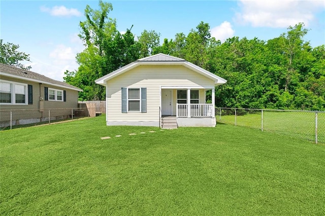 131 Hickory St, Reserve, LA 70084 - back of property with a fenced backyard, a yard, and covered porch