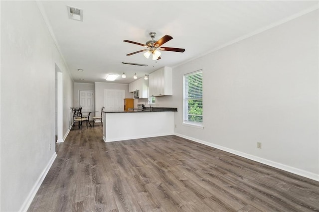 131 Hickory St, Reserve, LA 70084 - unfurnished living room with a ceiling fan, baseboards, dark wood finished floors, and crown molding