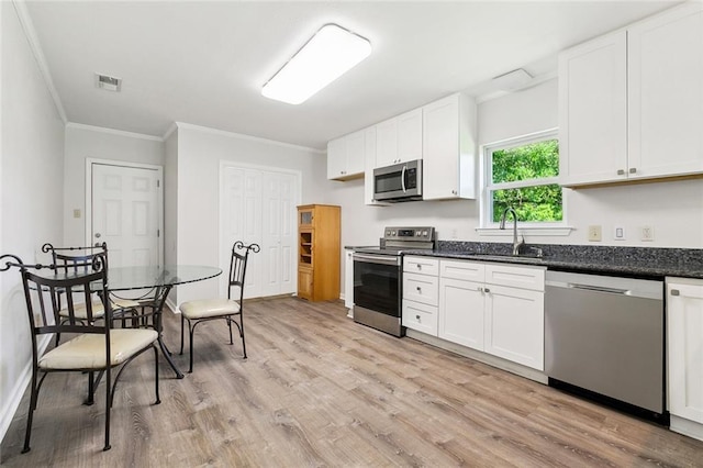 131 Hickory St, Reserve, LA 70084 - kitchen with crown molding, a sink, light wood finished floors, appliances with stainless steel finishes, and visible vents
