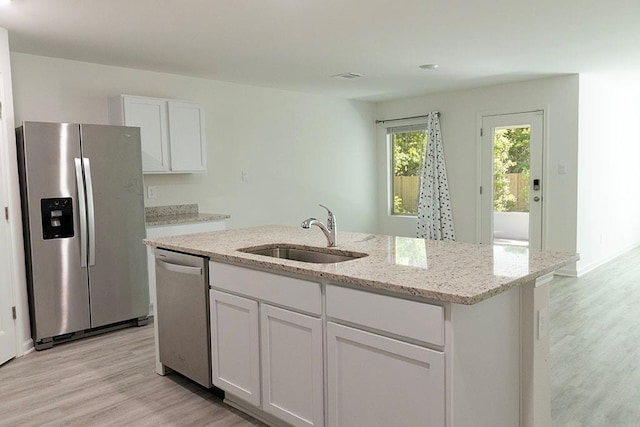 40495 Cara Mae St, Slidell, LA 70461 - kitchen with white cabinets, appliances with stainless steel finishes, a sink, and light wood-style flooring