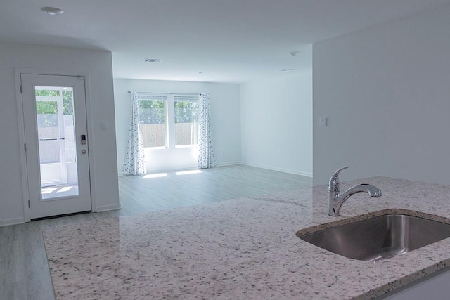 40495 Cara Mae St, Slidell, LA 70461 - kitchen with visible vents, light stone countertops, wood finished floors, a sink, and baseboards