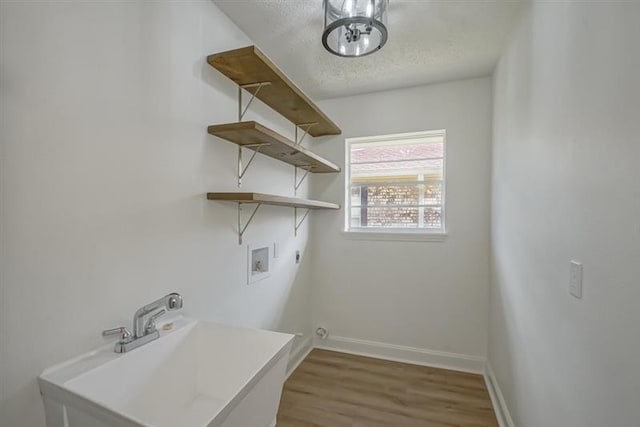 washroom with laundry area, baseboards, hookup for a washing machine, a textured ceiling, and electric dryer hookup