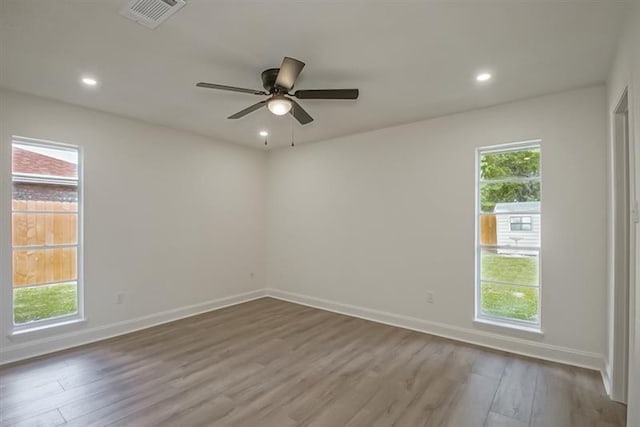 unfurnished room with visible vents, wood finished floors, baseboards, ceiling fan, and recessed lighting