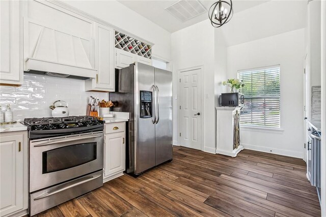 126 Woodchase Dr, Belle Chasse, LA 70037 - kitchen with stainless steel appliances, visible vents, dark wood-style flooring, backsplash, and custom range hood