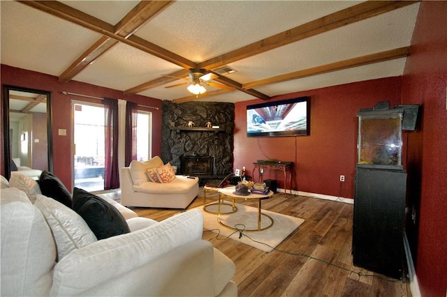 3209 Jennifer Ct, Marrero, LA 70072 - living area featuring hardwood / wood-style floors, a fireplace, baseboards, beamed ceiling, and ceiling fan
