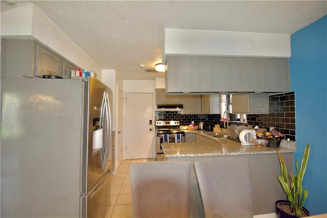 3209 Jennifer Ct, Marrero, LA 70072 - kitchen featuring stainless steel appliances, under cabinet range hood, a sink, a peninsula, and backsplash