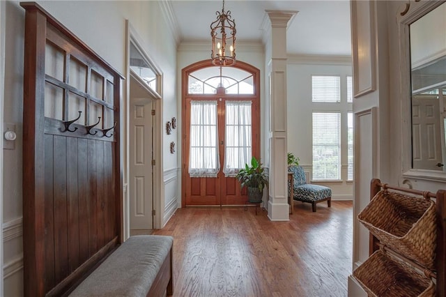 265 Remington Dr, Mandeville, LA 70448 - entrance foyer featuring light wood finished floors, a healthy amount of sunlight, an inviting chandelier, and crown molding