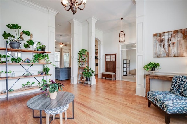 265 Remington Dr, Mandeville, LA 70448 - sitting room featuring ornamental molding, arched walkways, a notable chandelier, and light wood-style floors
