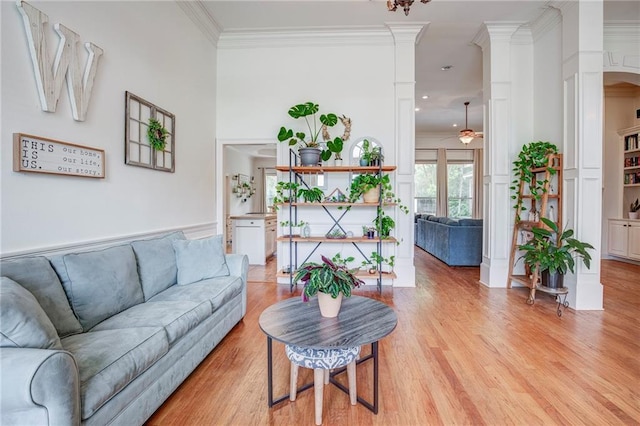 265 Remington Dr, Mandeville, LA 70448 - living room featuring light wood-type flooring, ceiling fan, ornamental molding, and decorative columns