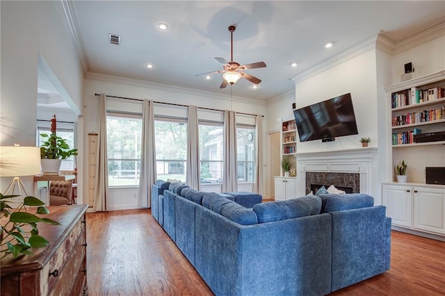 265 Remington Dr, Mandeville, LA 70448 - living area featuring ceiling fan, ornamental molding, wood finished floors, and a high end fireplace
