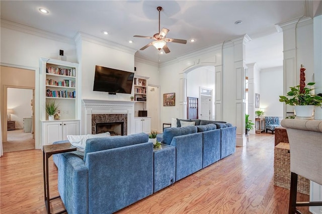 265 Remington Dr, Mandeville, LA 70448 - living room with recessed lighting, a ceiling fan, light wood-type flooring, decorative columns, and a fireplace