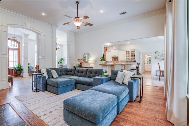 265 Remington Dr, Mandeville, LA 70448 - living room with ceiling fan, ornamental molding, light wood-style flooring, and decorative columns