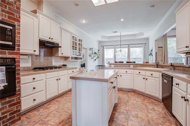 265 Remington Dr, Mandeville, LA 70448 - kitchen with black appliances, a tray ceiling, a sink, and white cabinets