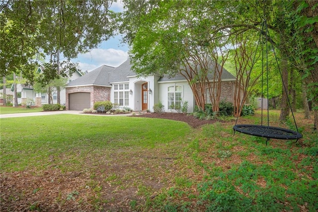 265 Remington Dr, Mandeville, LA 70448 - view of front of house featuring a trampoline, driveway, an attached garage, a front yard, and stucco siding
