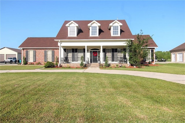 4540 Barataria Blvd, Marrero, LA 70072 - new england style home featuring covered porch, a front lawn, and brick siding