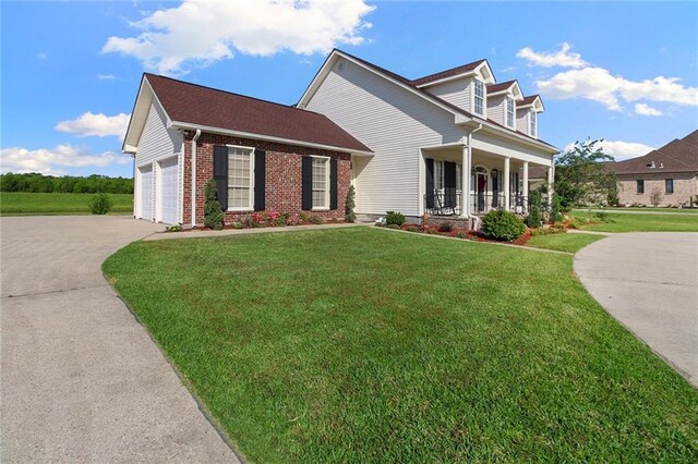 4540 Barataria Blvd, Marrero, LA 70072 - cape cod home with concrete driveway, a front lawn, a porch, and brick siding