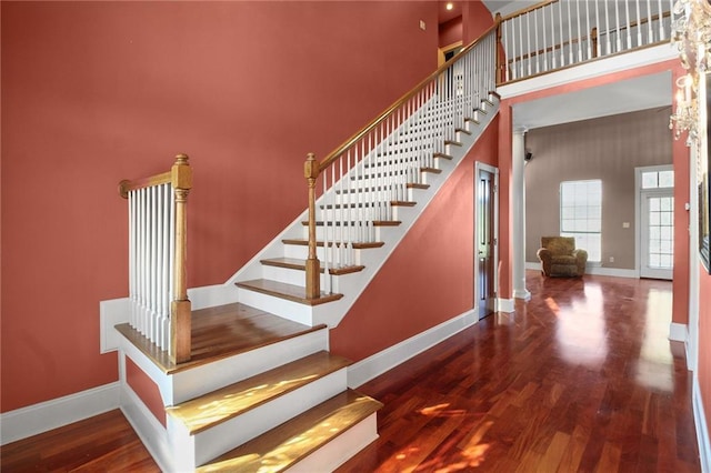 4540 Barataria Blvd, Marrero, LA 70072 - staircase with a towering ceiling, baseboards, and wood finished floors