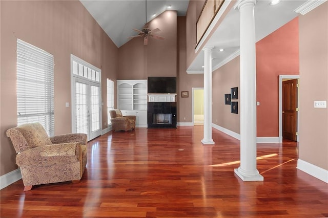 4540 Barataria Blvd, Marrero, LA 70072 - living room with ornate columns, high vaulted ceiling, a ceiling fan, wood finished floors, and a tile fireplace