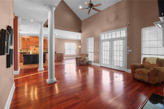 4540 Barataria Blvd, Marrero, LA 70072 - living area featuring decorative columns, ceiling fan, a towering ceiling, wood finished floors, and baseboards