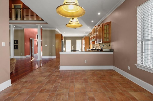 4540 Barataria Blvd, Marrero, LA 70072 - kitchen with ornate columns, brown cabinets, crown molding, glass insert cabinets, and recessed lighting