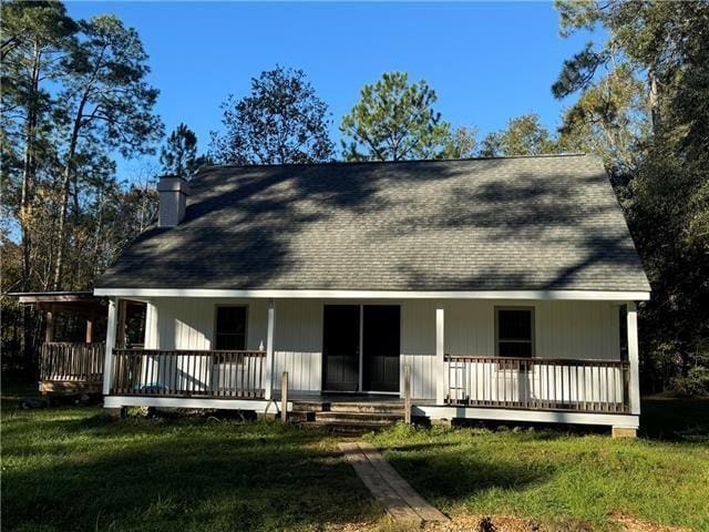 103 Marigold Dr, Covington, LA 70433 - back of property with covered porch, a yard, a chimney, and a shingled roof