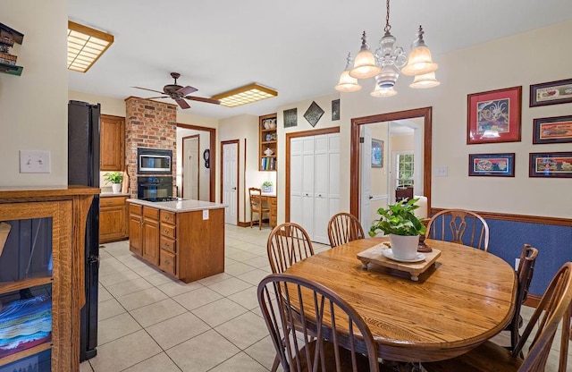 dining room with light tile patterned floors and ceiling fan with notable chandelier