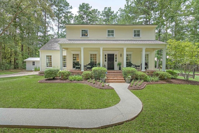 view of front of house featuring a porch, a shingled roof, and a front lawn