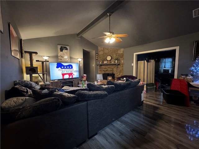 living room featuring ceiling fan, visible vents, a fireplace, wood finished floors, and vaulted ceiling with beams