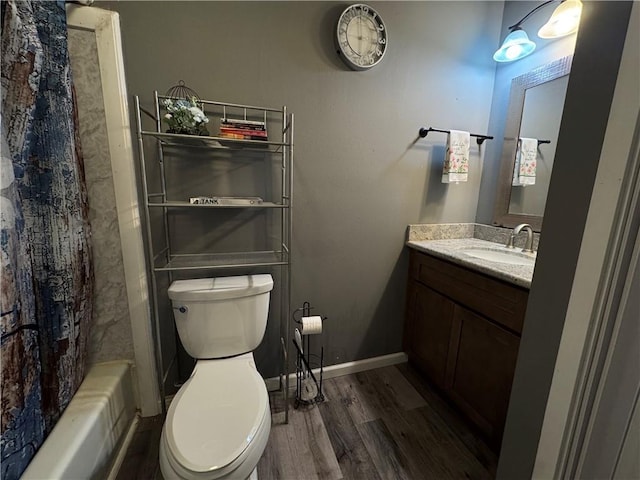 full bath featuring toilet, vanity, shower / bath combo with shower curtain, and wood finished floors
