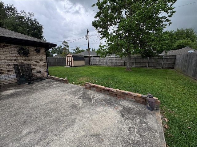 view of yard with an outbuilding, a storage shed, a fenced backyard, and a patio area