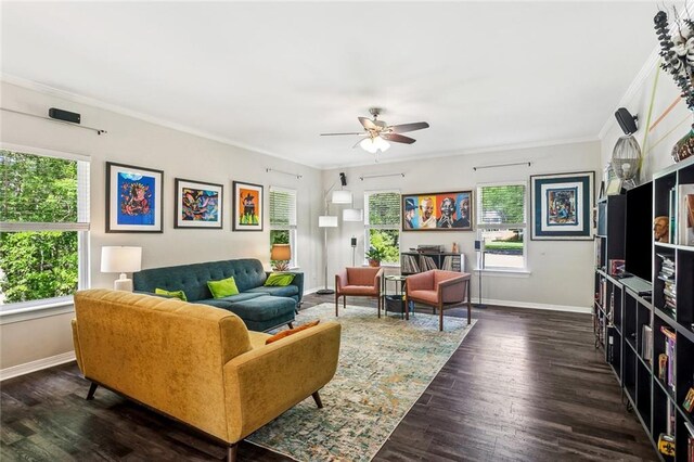 living area featuring baseboards, ornamental molding, and a healthy amount of sunlight