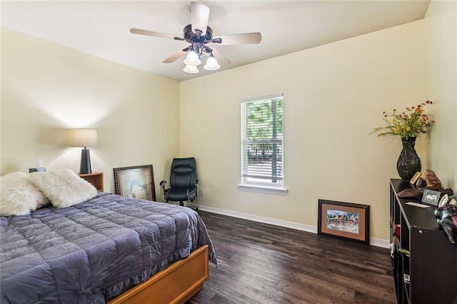 bedroom featuring a ceiling fan, baseboards, and dark wood-style floors
