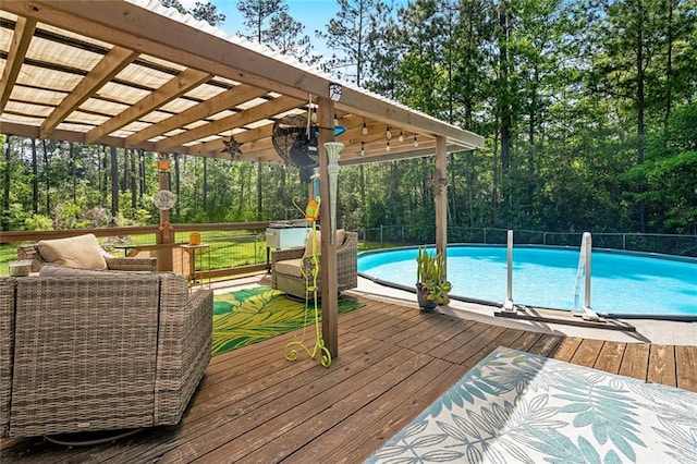 view of pool with a pergola, an outdoor living space, a deck, fence, and a fenced in pool