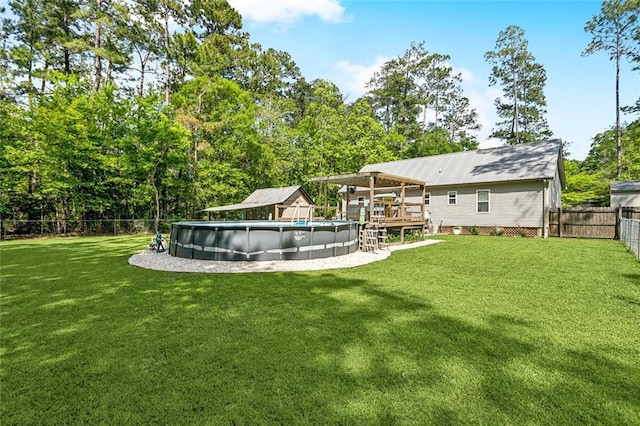 view of yard featuring a fenced backyard, a fenced in pool, and a deck