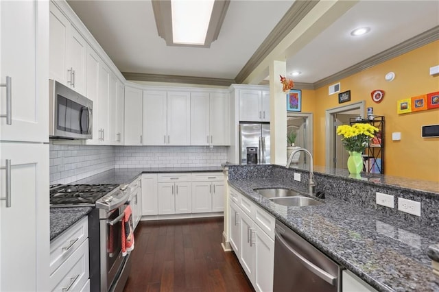 2634 Marengo St, New Orleans, LA 70115 - kitchen featuring stainless steel appliances, a sink, white cabinetry, and ornamental molding