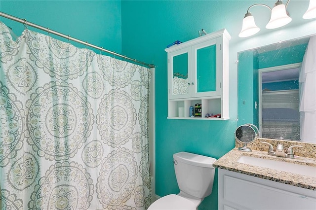 bathroom featuring vanity, curtained shower, and toilet