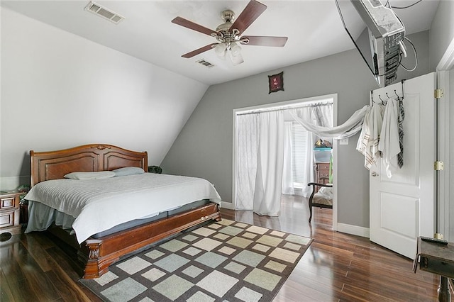 bedroom featuring baseboards, wood finished floors, visible vents, and a ceiling fan